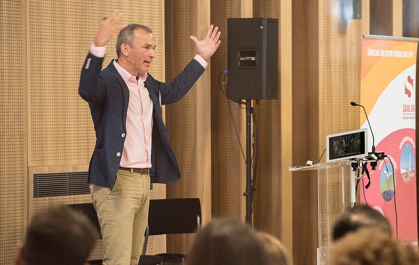 Istvan Joos speaking on stage
